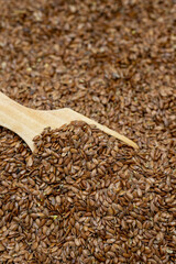 Flax seeds background or texture. Flaxseed or linseed in wooden spoon. cereals healthy food