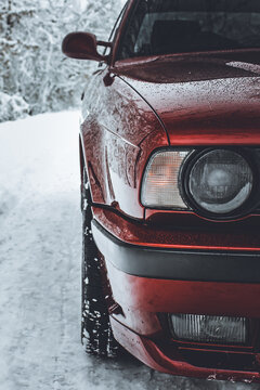 Chernigov, Ukraine - December 21, 2017: BMW 520 (E34) in the winter forest. Red BMW in a beautiful forest. Nature. Snow