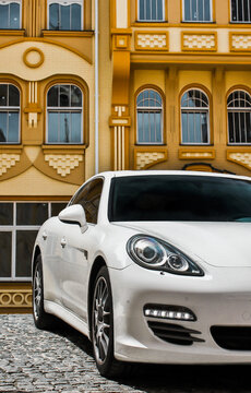 Kyiv, Ukraine - June 1, 2013: White luxury car Porsche Panamera 4S on the background of beautiful buildings