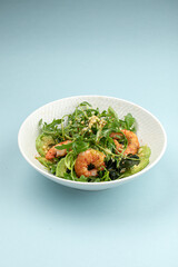 Portion of healthy gourmet shrimp salad with avocado