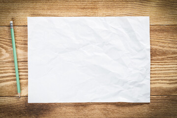 Sheet of paper lying on wooden table