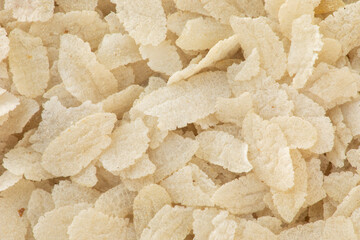 Poha, flattened rice background texture. Basis for Indian breakfast or snack (kanda poha, batata poha, poha chivda).
