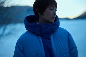朝方,冬の山にいるショートヘアの女性