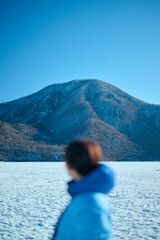 冬の山にいるショートヘアの女性