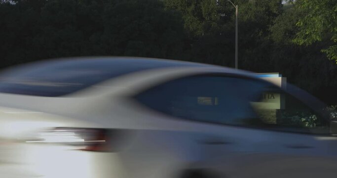 Marquee welcoming people to the city of Santa Clarita in northern Los Angeles County, California with traffic passing by. Real time static shot of Santa Clarita sign.