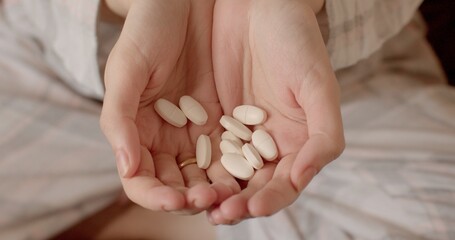 Close-up of hands with pills. Lots of pills ready to use. Maintenance of the body with medicines. Treatment of a person's mental health