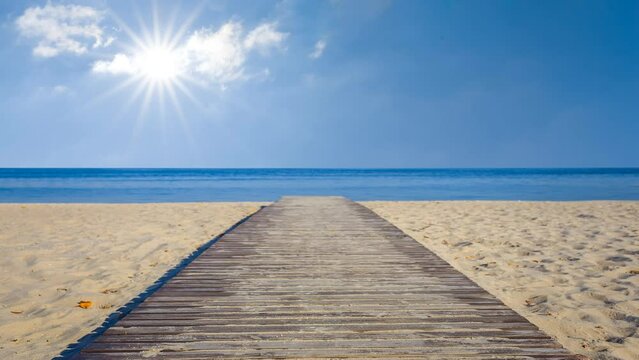 wooden road on sandy beachat hot sunny day time lapse scene