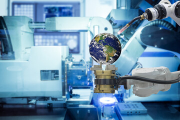 Close-up industrial gripping and welding robotic working with Globe Earth to upgrade a new Globe with high technology on smart factory, concept idea, Element of this furnished by NASA