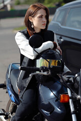 woman in motorcycle clothes motorcyclist with a helmet. Biker woman.