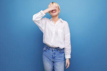 shy pretty blond office worker woman in white shirt and jeans. people lifestyle concept