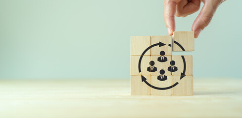 Job rotation management concept. Forecasting future staffing needs, analyzing current staffing levels and developing human resource strategies. Wooden blocks with manpower or staffs icons.