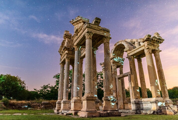 Temple columns of the ancient city of Aphrodisias. Starry sky and night scene in the background.