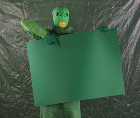 green alien with green poster
