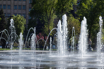 Fountains water drops close-up on Freedom square in Kharkiv city center. Tourist attraction and recreation area in spring
