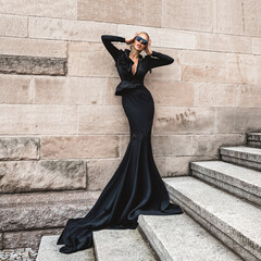 Elegant luxury evening fashion. Glamour, stylish elegant woman in black long evening gown dress is...