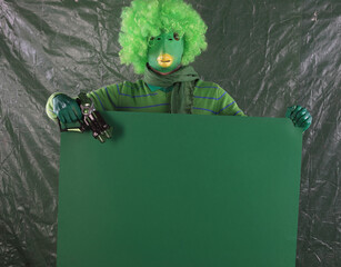 green alien with green poster