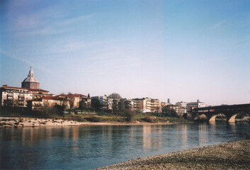 Fototapeta premium Pavia Cityscape View from Ticino River. Pavia, Italy. Film Photography