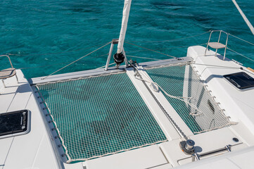 From above of net on deck of modern catamaran sailing in sea on sunny day in summer