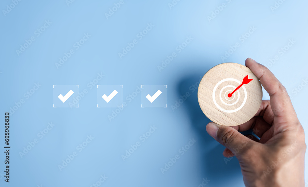 Aufkleber Hand holding wooden block with Quality Assurance or QA and Quality Control or QC and improvement. Standardization, certification. Compliance to regulations service and standards.