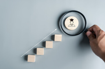 Steps of education leading to success goal. Taking strategic steps towards graduation. Career path and first for business, Graduation achievement goals concept. Graduation cap into Magnifying glass.