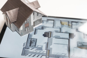 architecture, building, construction, real estate and home concept - close up of living house model on tablet pc computer screen.