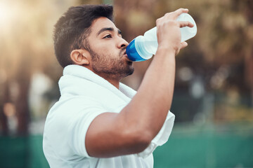 Man, fitness and drinking water on tennis court after workout, match or game practice outdoors....