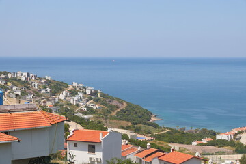 Obraz premium View of the highway, houses and mountains on the Aegean coast of Turkey, orange groves. Türkiye, May 2023.