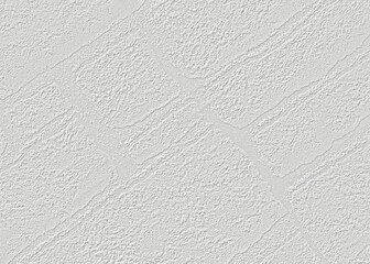 On a light gray paper wallpaper with a texture of bricks arranged diagonally.