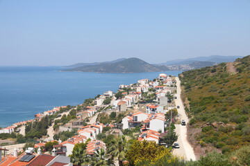 Fototapeta premium View of the highway, houses and mountains on the Aegean coast of Turkey, orange groves. Türkiye, May 2023.