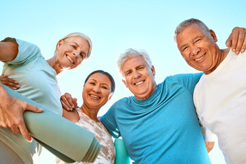 Fitness, portrait and senior friends at yoga outdoor at a wellness, health and spiritual resort. Happy, smile and low angle of a group of elderly people in a huddle at a pilates or meditation class.