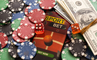 Mobile phone with bets, cards, chips, cubes and money dollars. Concept application for smartphone gambling, electronic casino online