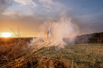Obraz premium young guy crying in fire in burnt clothes, war, home destruction, human disappointment