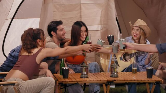 Happy young friends traveler group having fun music together in camping party, Group of multiculturalism hipster people enjoying holiday vacation trip in campsite