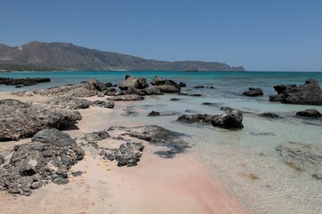 Beautiful shot of the rocky pink beach shore of the Mediterranean Sea in Crete, Greece
