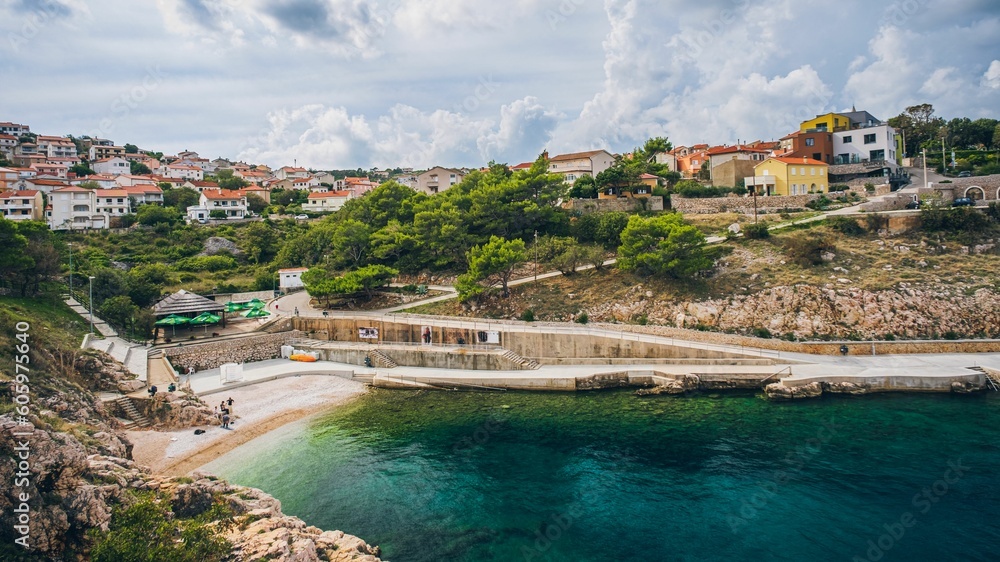 Sticker Beautiful view of the Vrbnik village on the seashore under a cloudy sky in Croatia