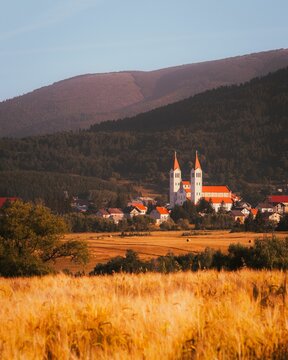 Vertical of the church towers of a church in Kupres against a scenic landscape, Bosnia Herzegovina