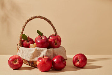 Fresh apples are placed inside a bamboo basket against pastel background. Product extracted from...