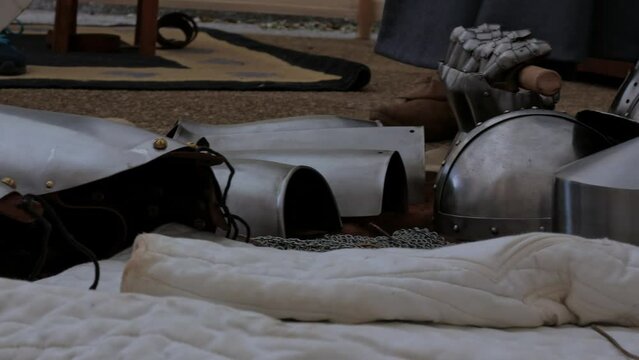 authentic medieval metal armor on display in a tent