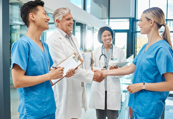 Healthcare, doctor and nurse handshake in a hospital to welcome or celebrate success. Men and women...