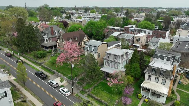 Houses in town during spring. Aerial rising shot of neighborhood housing in USA town.