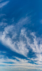 Naklejka na ściany i meble Fluffy clouds on a clear sunny day