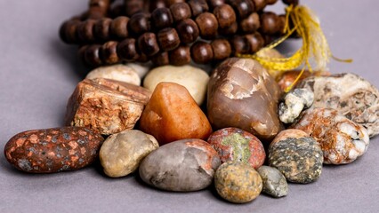 Closeup of holistic stones and bracelet isolated in gray background