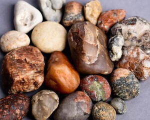 Close-up of the natural stones, placed by each other on a mauve purple background