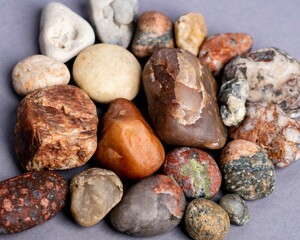 Closeup of a pile of crusher stones and pebbles on the gray background