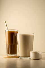 Protein powder in a scoop and a glass of protein drink. Bodybuilding, fitness sport, health and nutrition.