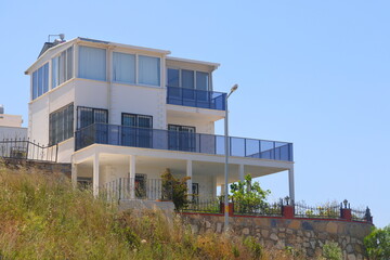 View of the highway, houses and mountains on the Aegean coast of Turkey, orange groves. Türkiye, May 2023.