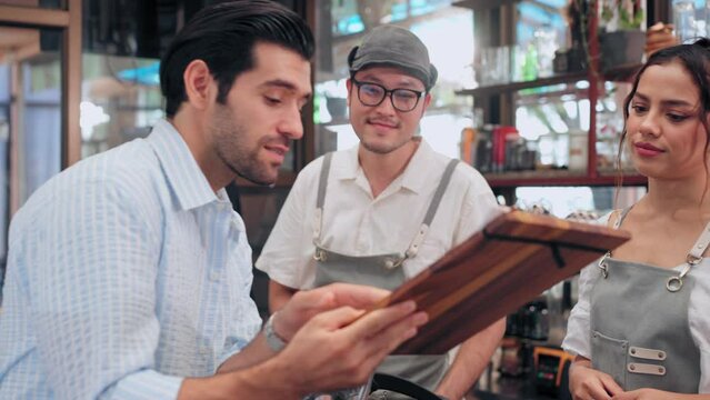 Customer man asking and interrogate the menu to barista in coffee shop or restaurant
