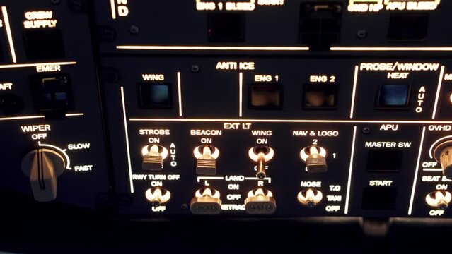 Pilot pressing on illuminated buttons on a plane for a flight simulator