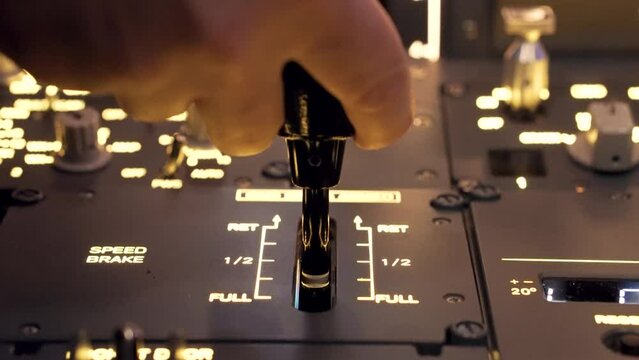 Pilot pressing on taking off button with illuminated dashboard during a flight simulator