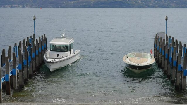Two Motorboats Moored and Rocking in the Waters of Brissago City on Lago Maggiore